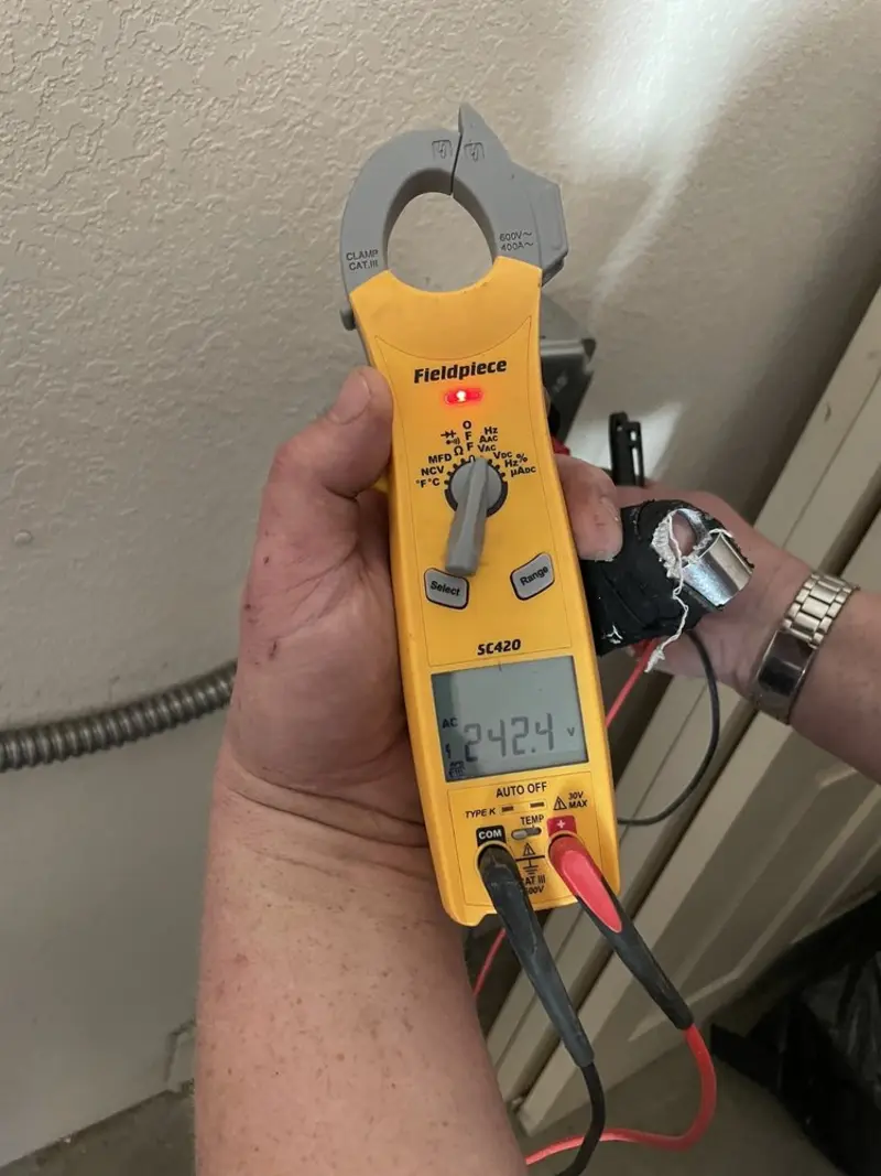 Voltage testing with clamp meter during Outlet Installation in Clayton